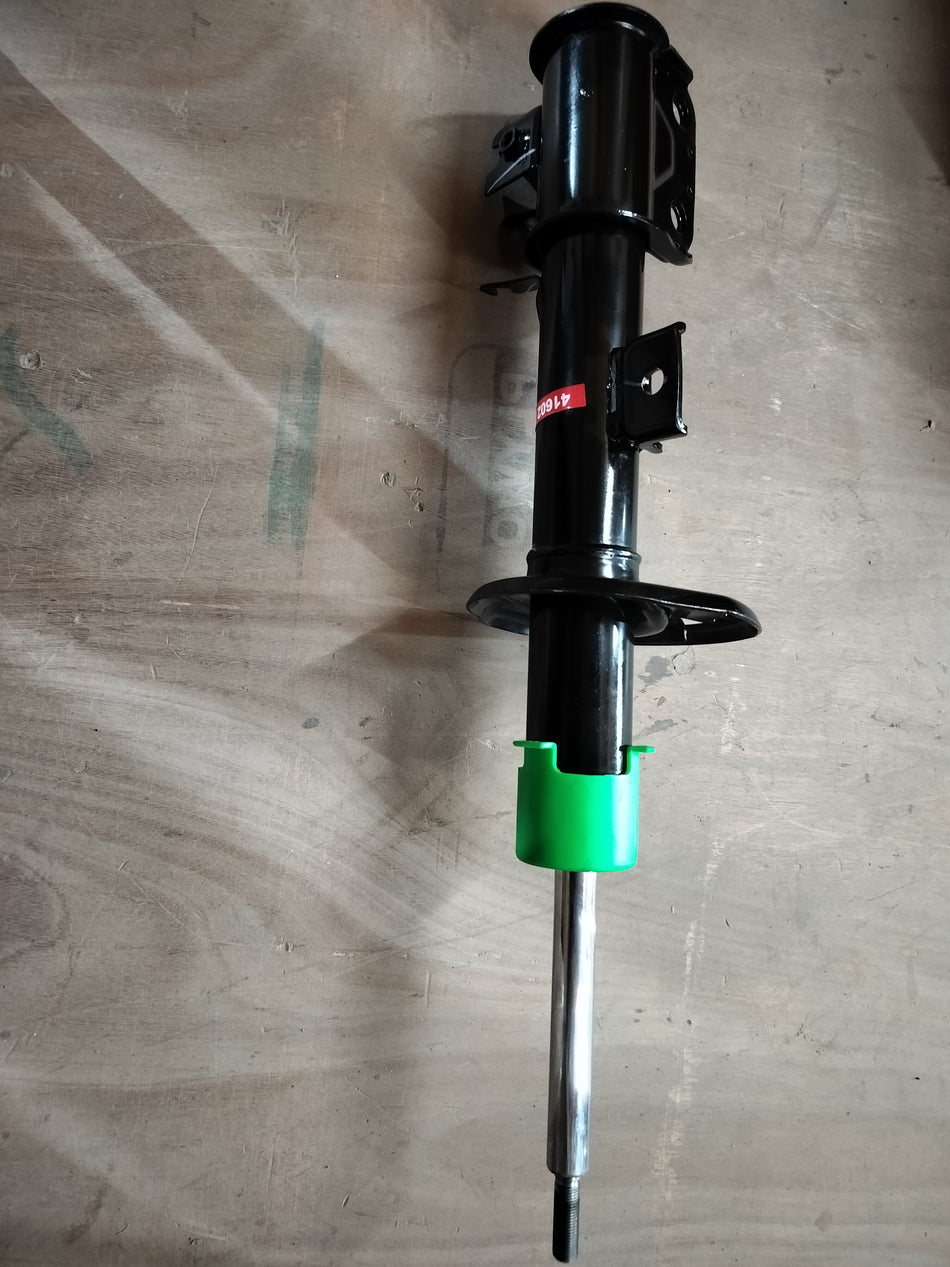 Front strut assembly for Maruti Suzuki vehicle, showing the suspension component with coil spring and mounting hardware.