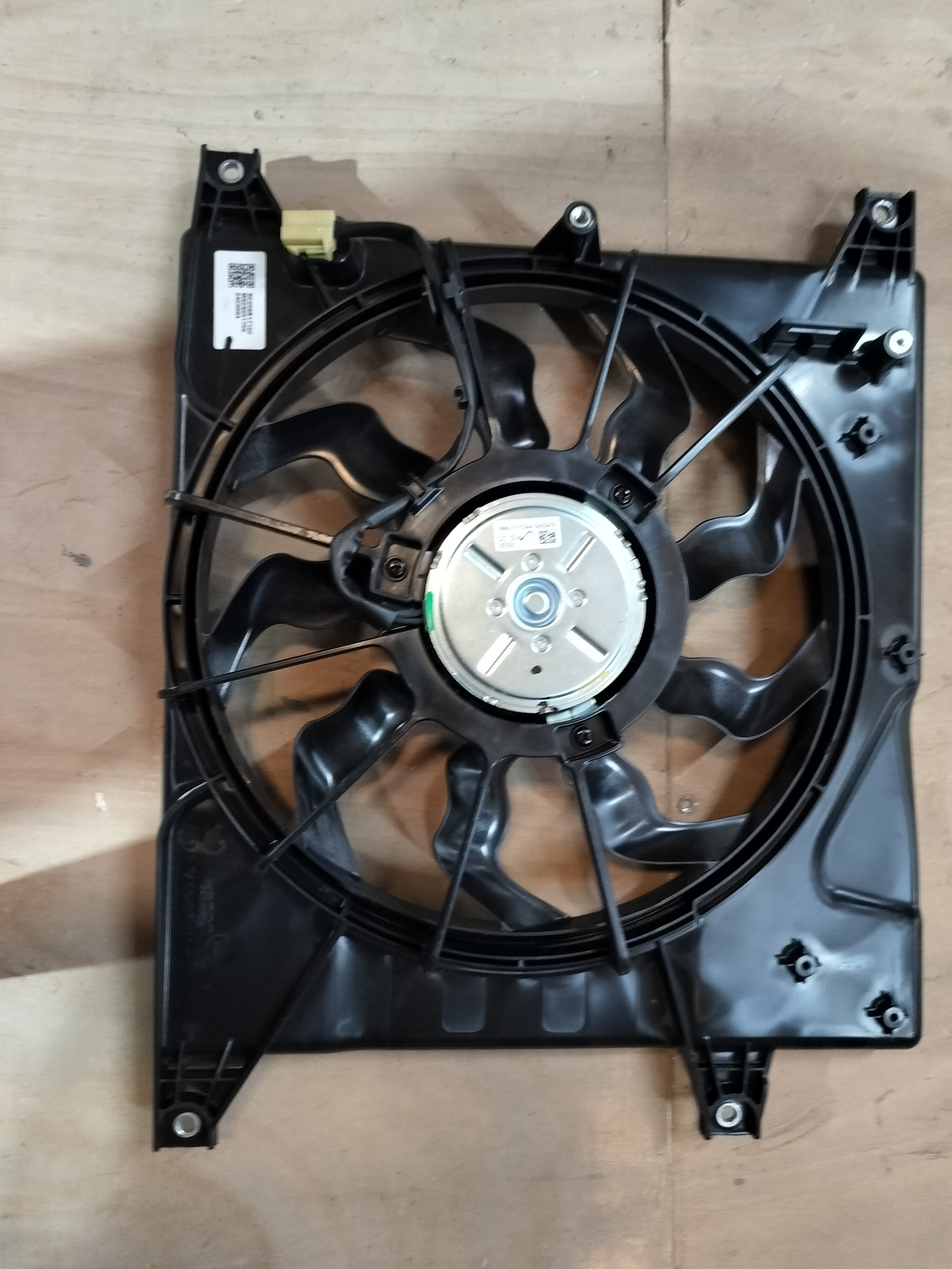 Maruti Suzuki radiator fan assembly for S-Presso vehicle, showing the black plastic fan and mounting components.