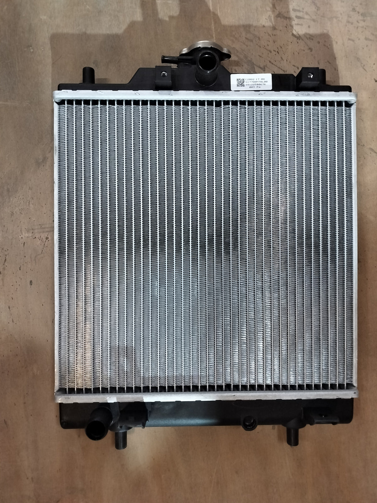Maruti Suzuki radiator for Eeco vehicle, part number 17700M78L00, shown in the image with a metallic core and fittings.