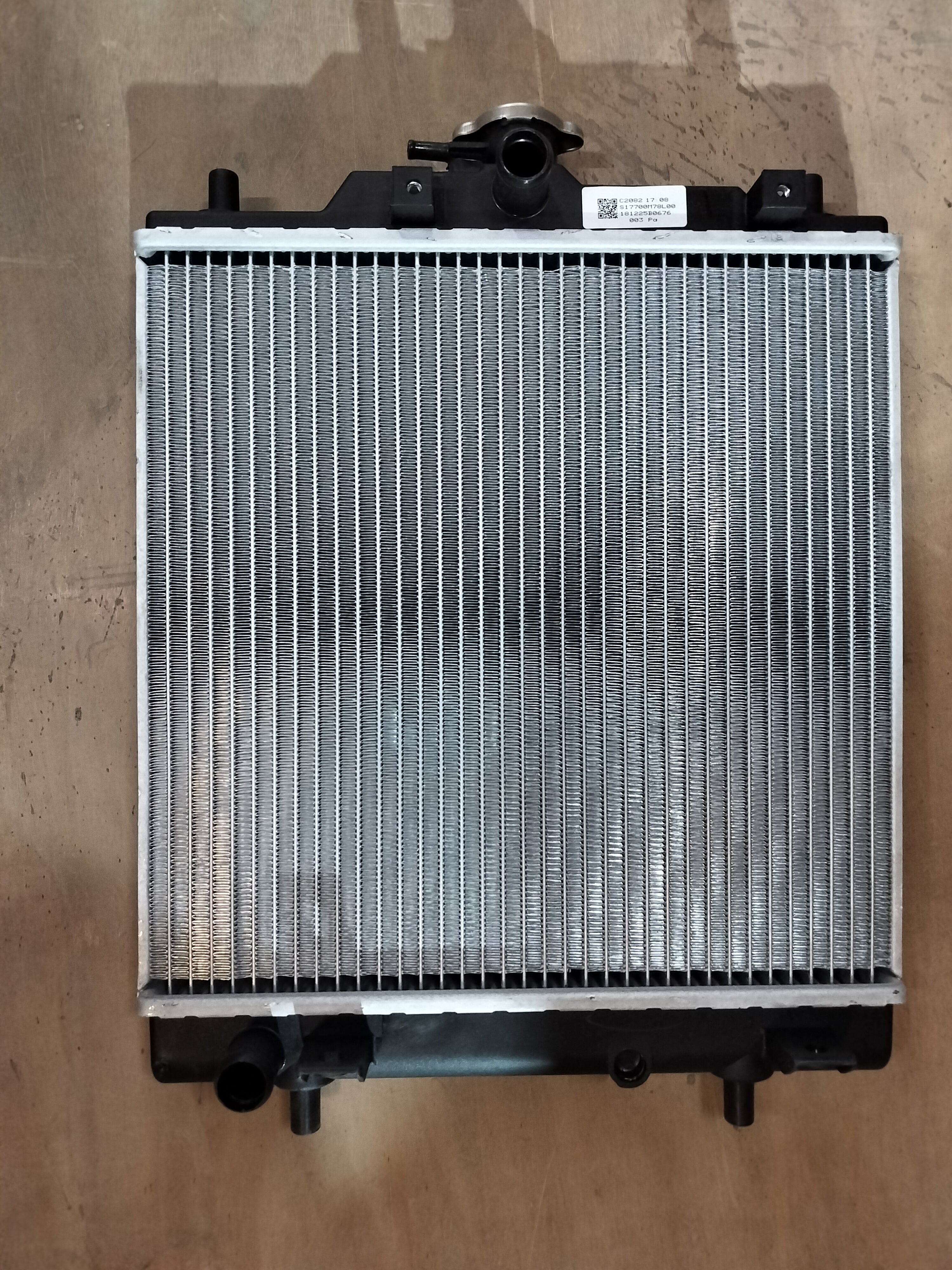 Maruti Suzuki radiator for Eeco vehicle, part number 17700M78L00, shown in the image with a metallic core and fittings.