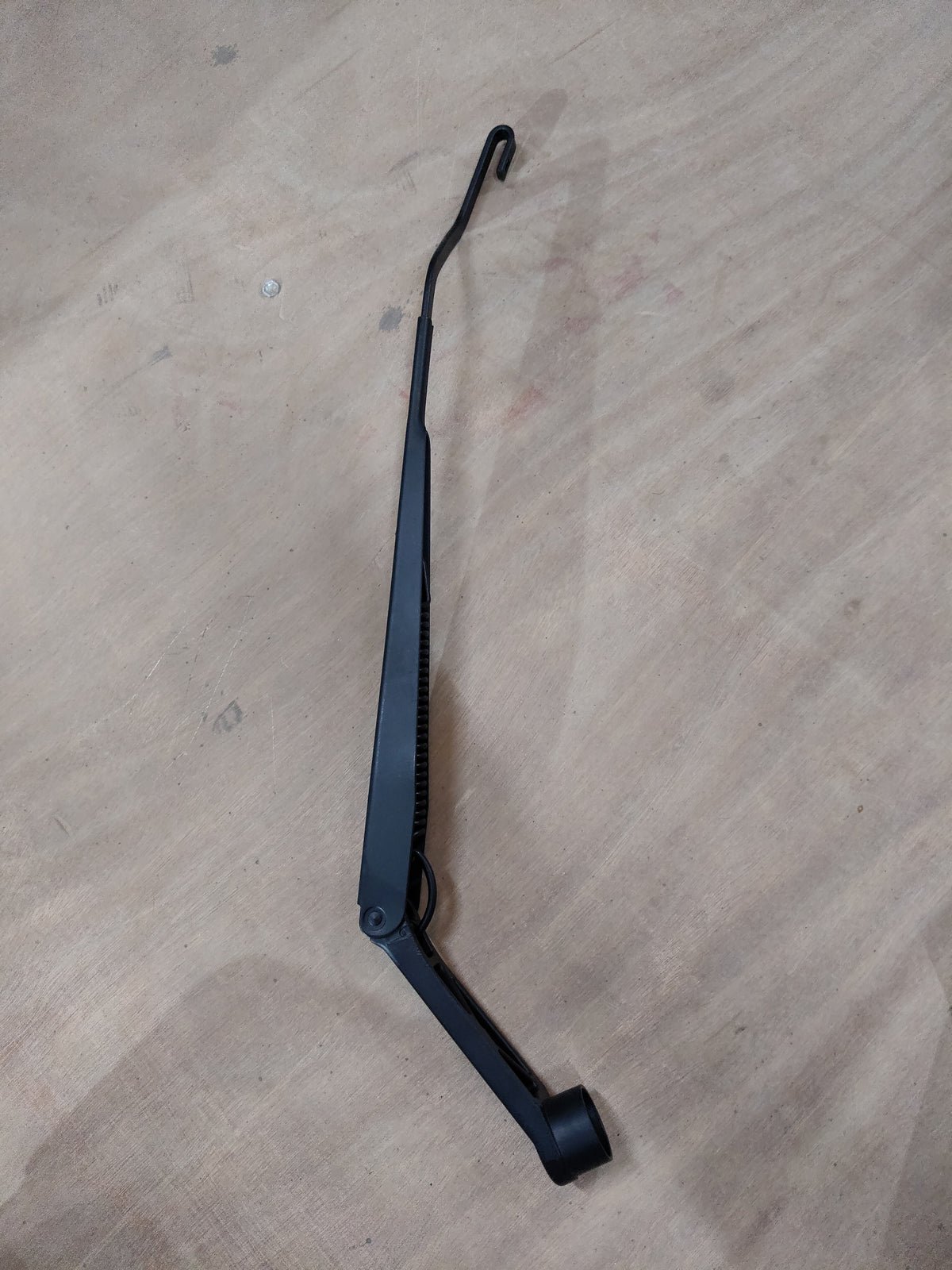 Maruti Suzuki arm assembly wiper driver part for Swift, Baleno, Brezza, Ertiga models, showing the wiper linkage component.