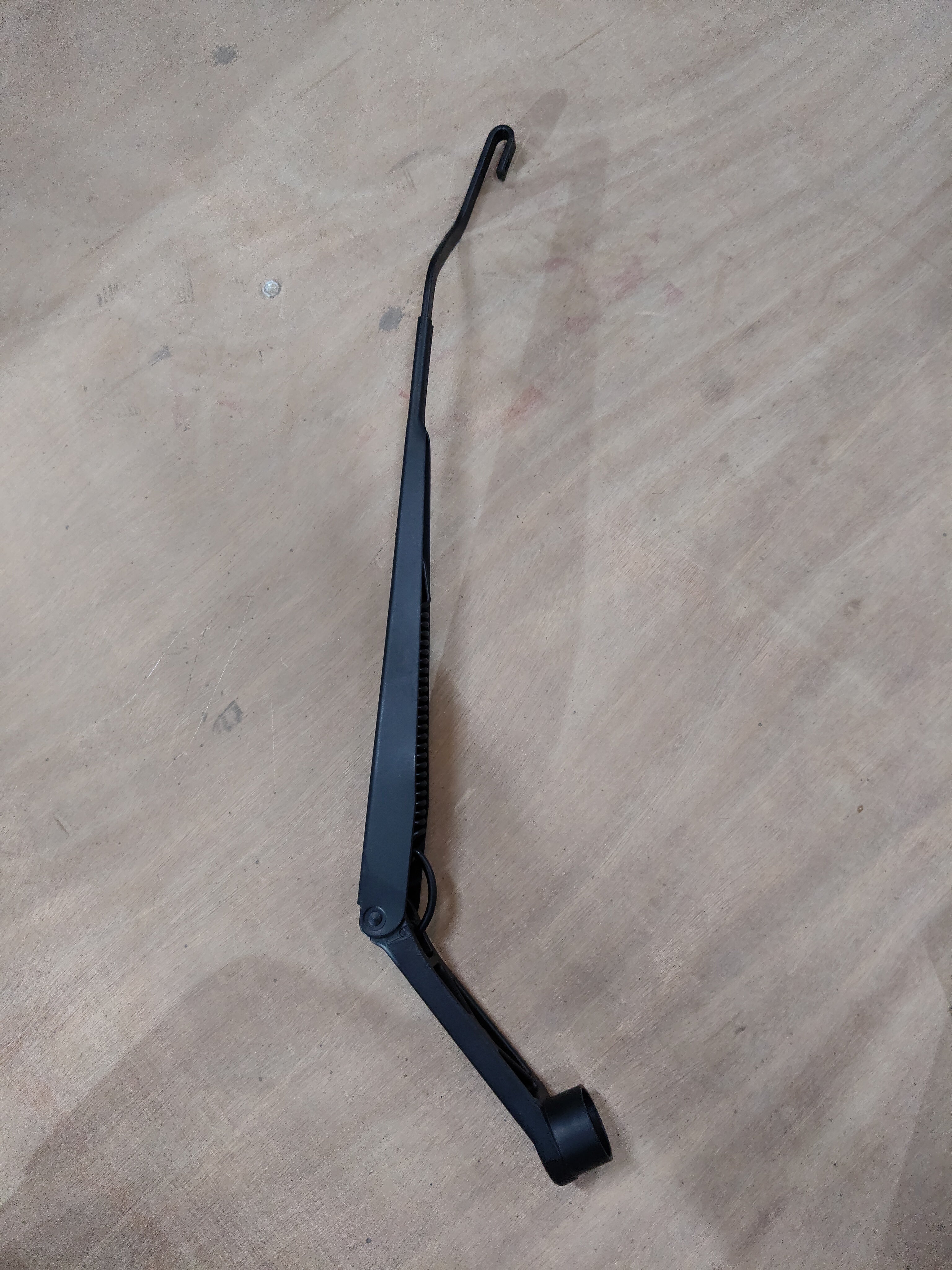 Maruti Suzuki arm assembly wiper driver part for Swift, Baleno, Brezza, Ertiga models, showing the wiper linkage component.