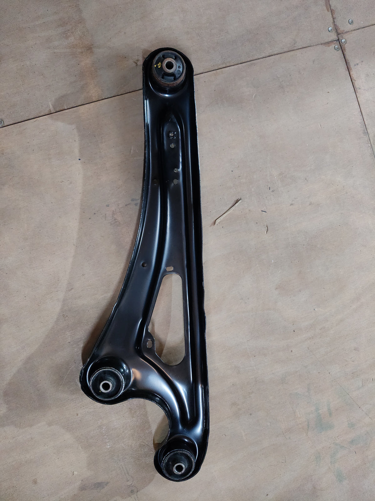Maruti Suzuki rear trailing arm assembly part 46201M67L00, vehicle suspension component, shown in the image.