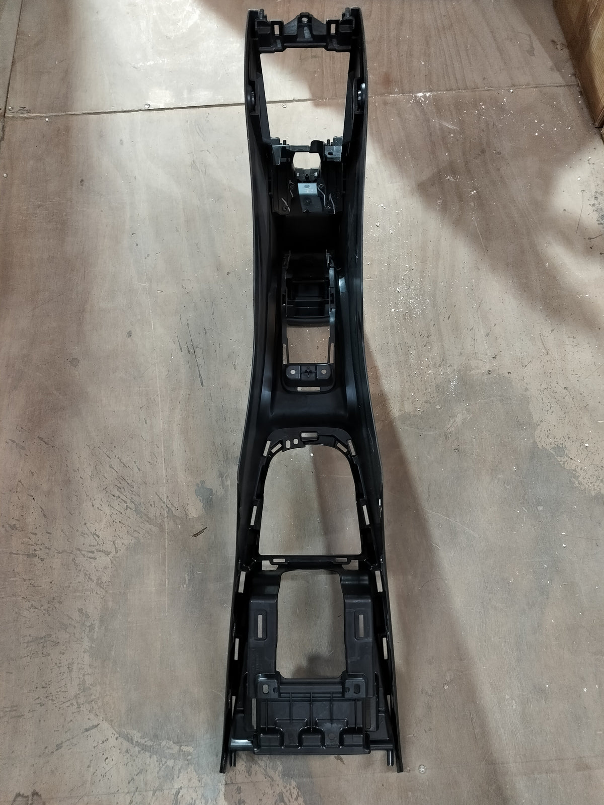 Maruti Suzuki floor console box in black with storage compartment and armrest for car interior.