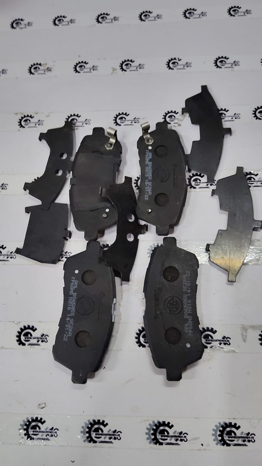 Maruti Suzuki brake pad set for Baleno 2nd Gen, with visible brake pads and packaging indicating part number 55810M69P00.