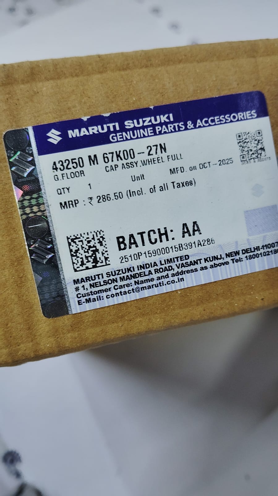 Maruti Suzuki full wheel cap assembly, part number 43250M67K0027N, showing the black plastic wheel cover with Maruti Suzuki logo