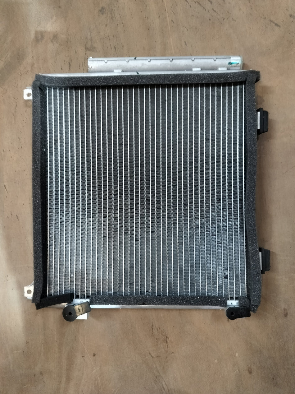Maruti Suzuki condenser assembly 95310M67L00, automotive cooling component with metal fins and connector, for vehicle air conditioning.