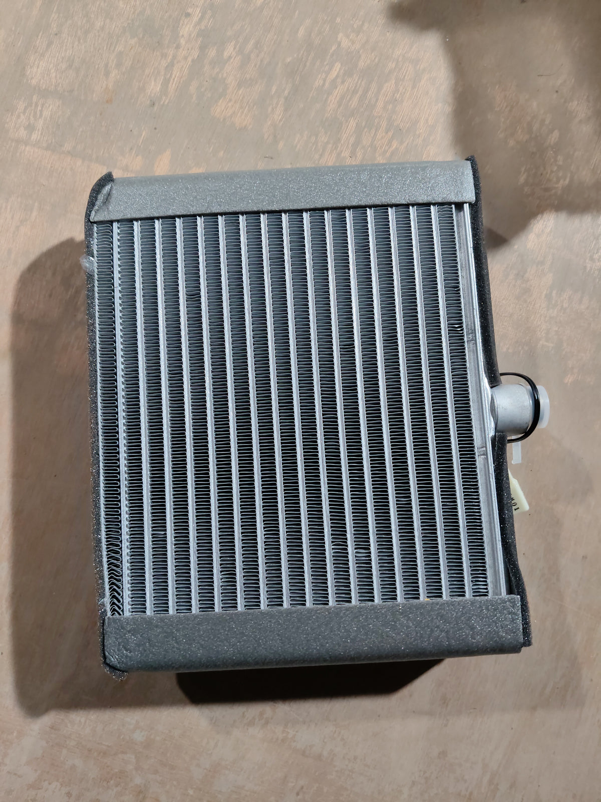 Cooling coil for Maruti Suzuki WagonR K-series engine, part number 95411M68K01, shown in a close-up view.