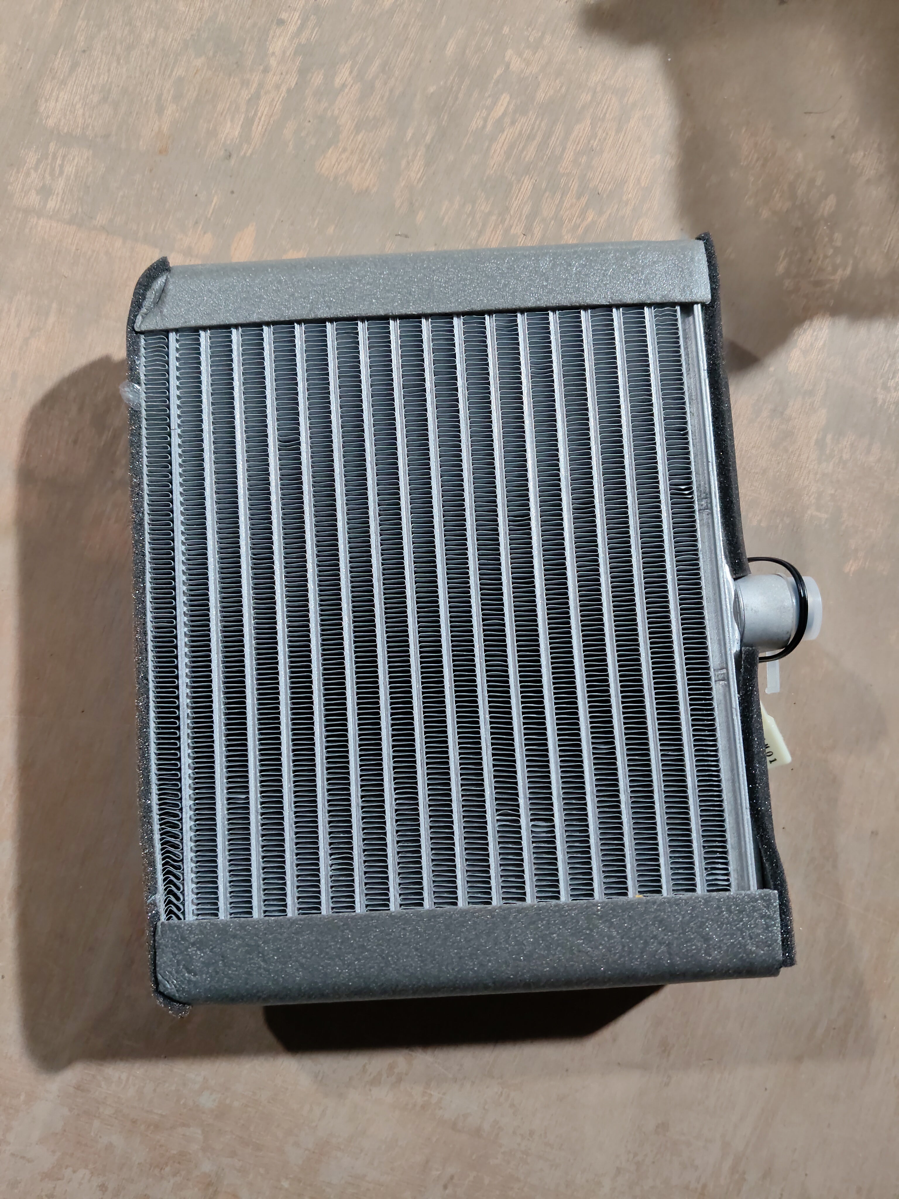 Cooling coil for Maruti Suzuki WagonR K-series engine, part number 95411M68K01, shown in a close-up view.