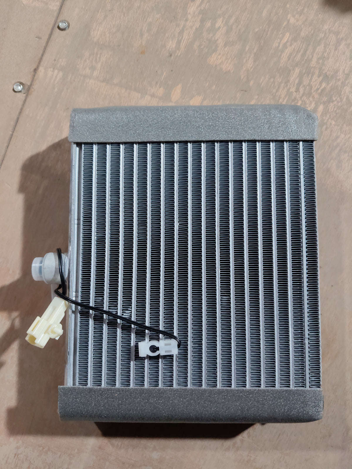 Maruti Suzuki cooling coil for Wagon R K-series engine, showing the metal coil component with electrical connections.