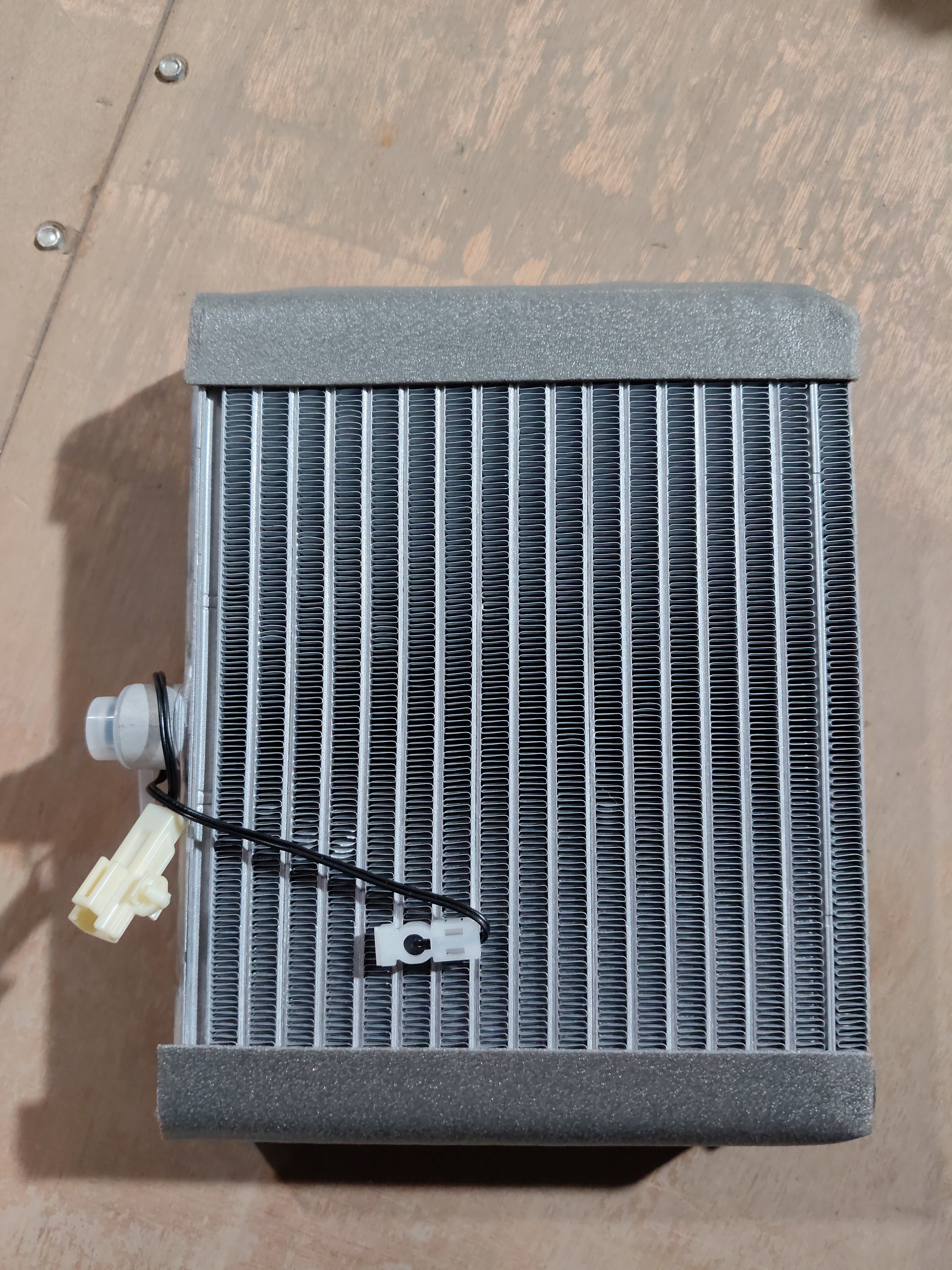 Maruti Suzuki cooling coil for Wagon R K-series engine, showing the metal coil component with electrical connections.