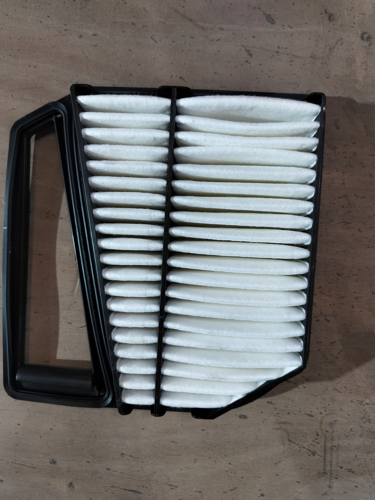Maruti Suzuki Element Air Cleaner 13780M66R50 installed in a vehicle engine compartment, showcasing the brand and product details.