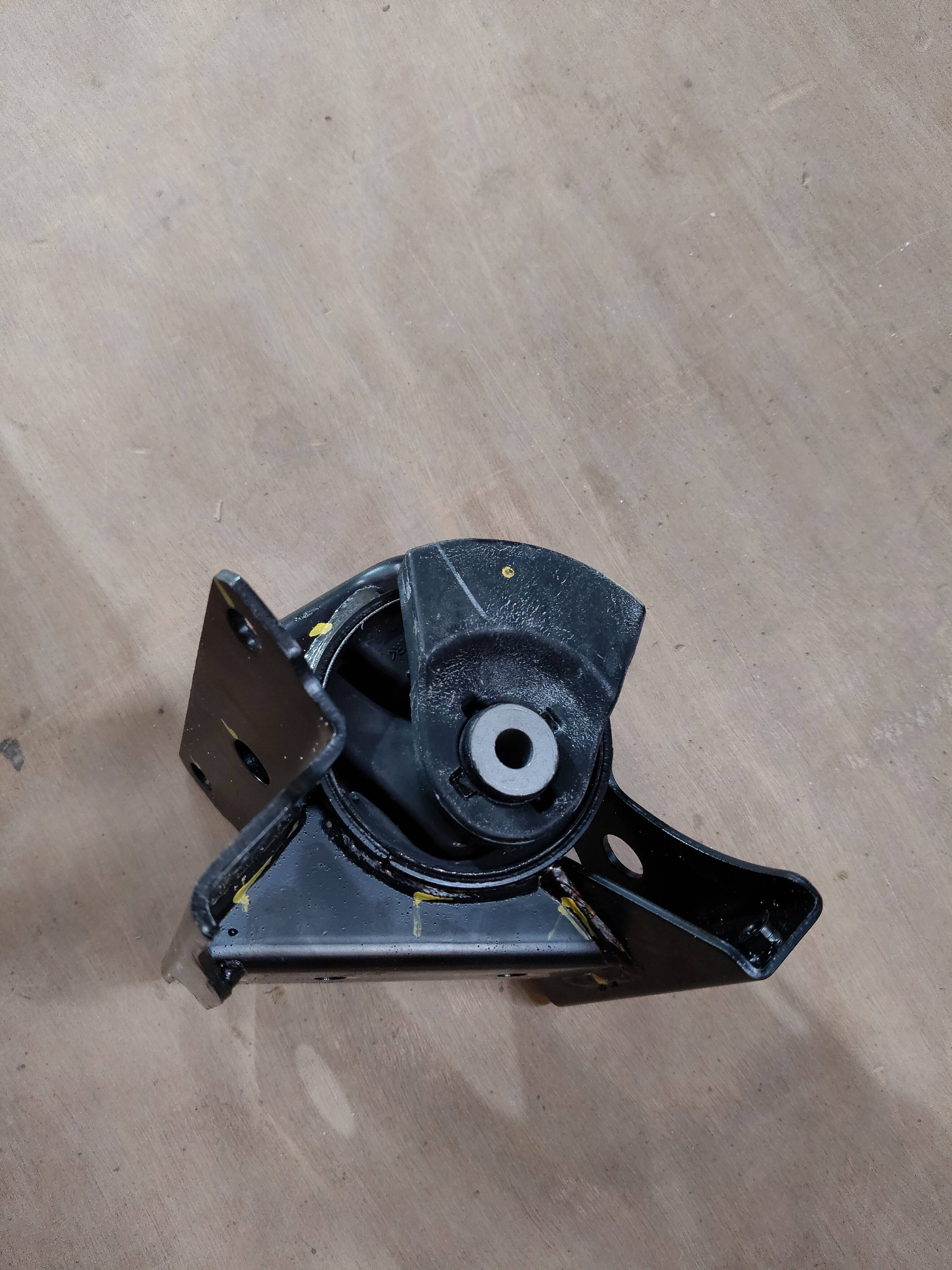Maruti Suzuki engine mounting for Celerio on the left side, showing the black rubber and metal components.