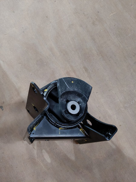 Maruti Suzuki engine mounting for Celerio on the left side, showing the black rubber and metal components.