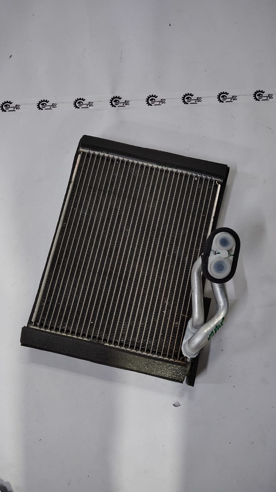 Maruti Suzuki Baleno evaporator sub assembly part, showing the cooling component for vehicle air conditioning system.