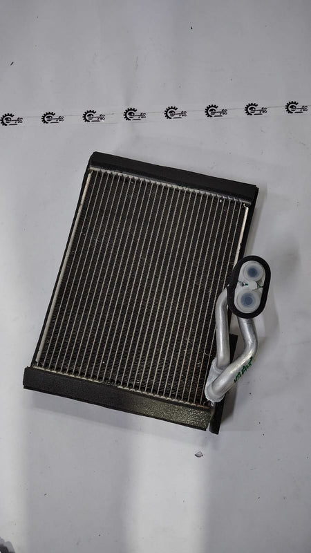 Maruti Suzuki Baleno evaporator sub assembly part, showing the cooling component for vehicle air conditioning system.