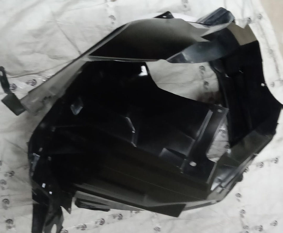 Maruti Suzuki Breeza left side fender lining, genuine car part with part number 72322M82P00, installed on vehicle body.