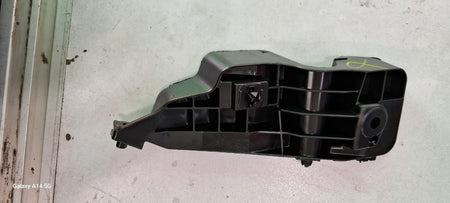 Maruti Suzuki front bumper bracket for Swift, showing the black metal component mounted on a vehicle.
