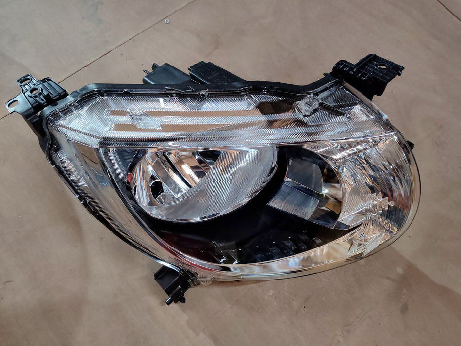 Maruti Suzuki Ignis head lamp assembly in black with clear lens, front view showing the headlight design and mounting points.