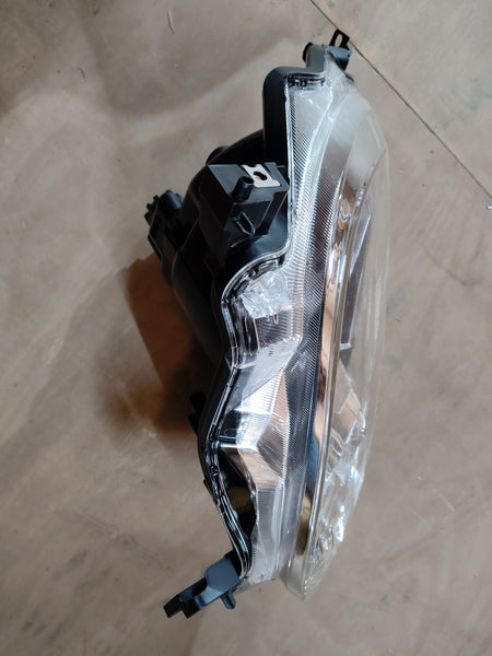 Maruti Suzuki Ignis head lamp assembly, model 35121M66R10, showing the front view with clear lens and mounting bracket.