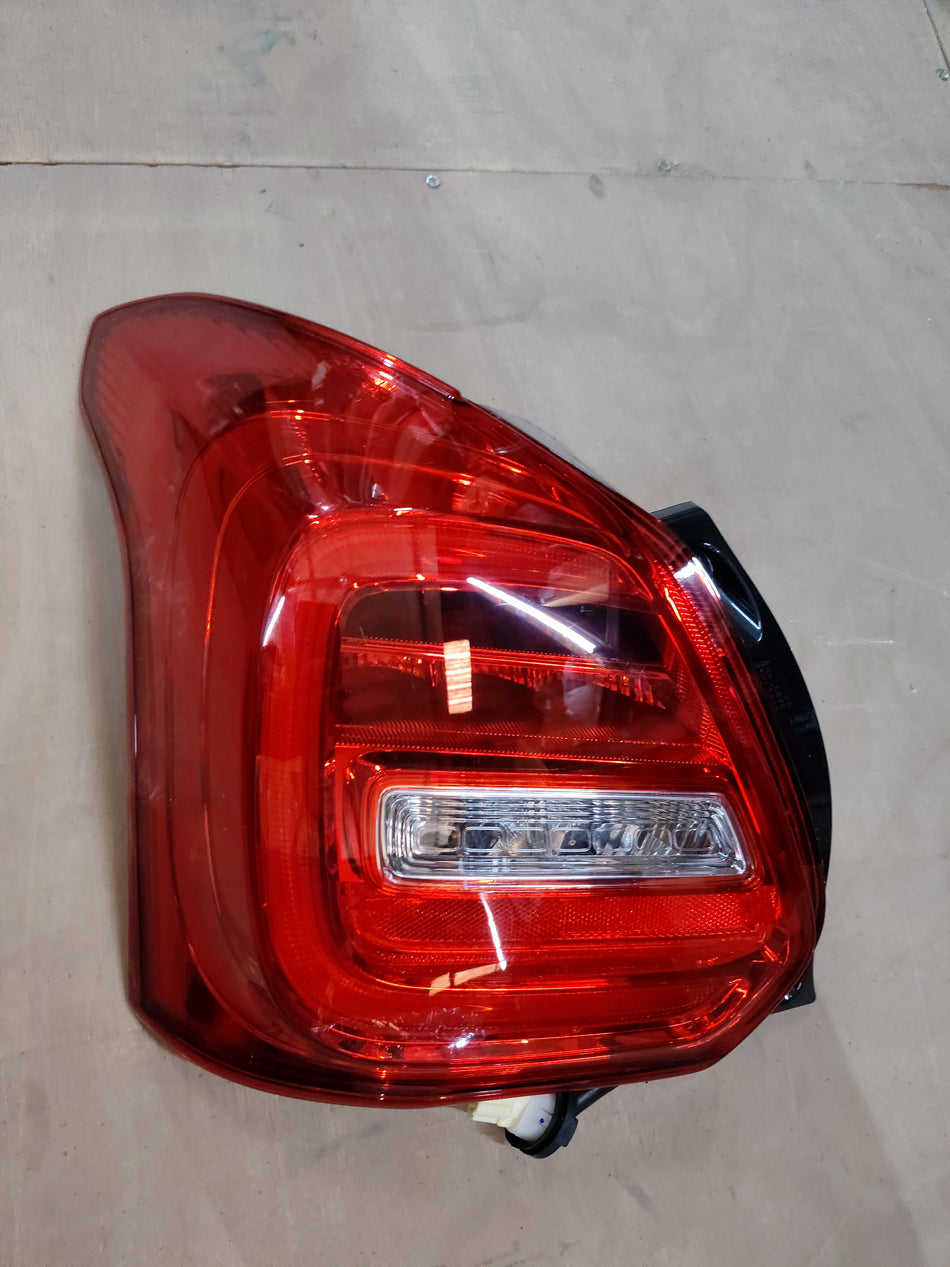 Maruti Suzuki lamp unit RR comb LH for vehicle, with clear view of the headlight assembly and wiring connection.