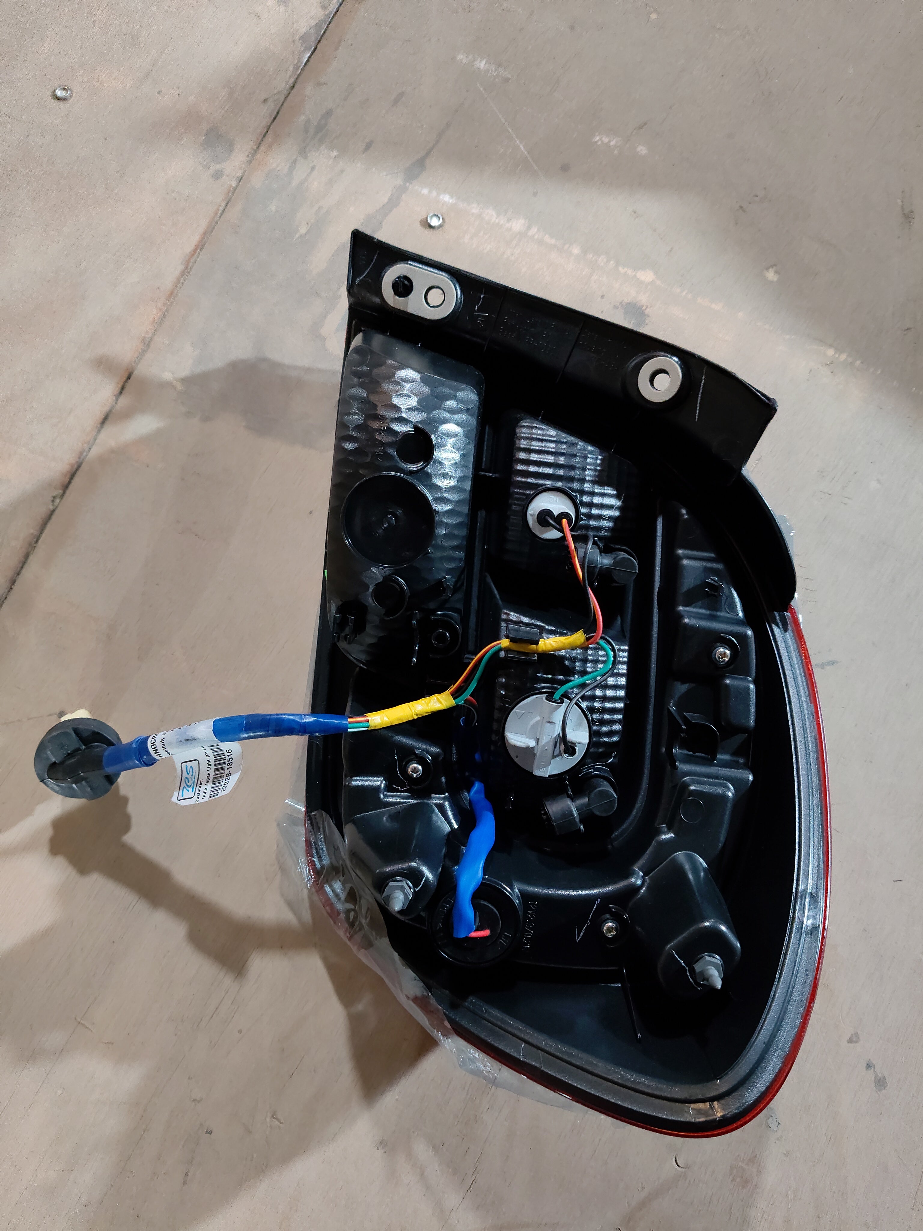Maruti Suzuki rear combination lamp unit for Alto K10, left-hand side, installed on the vehicle.