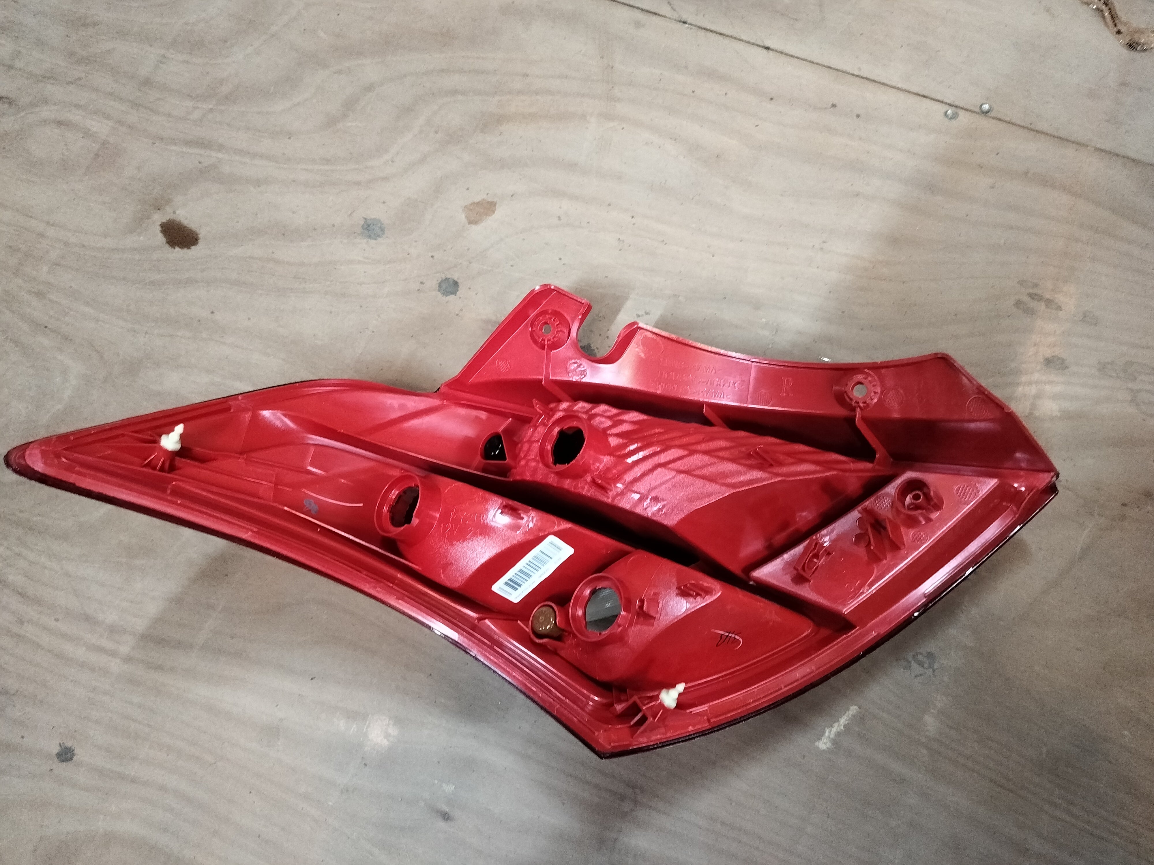 Maruti Suzuki tail lamp unit for right side of Swift car, featuring clear lens and red and white sections.