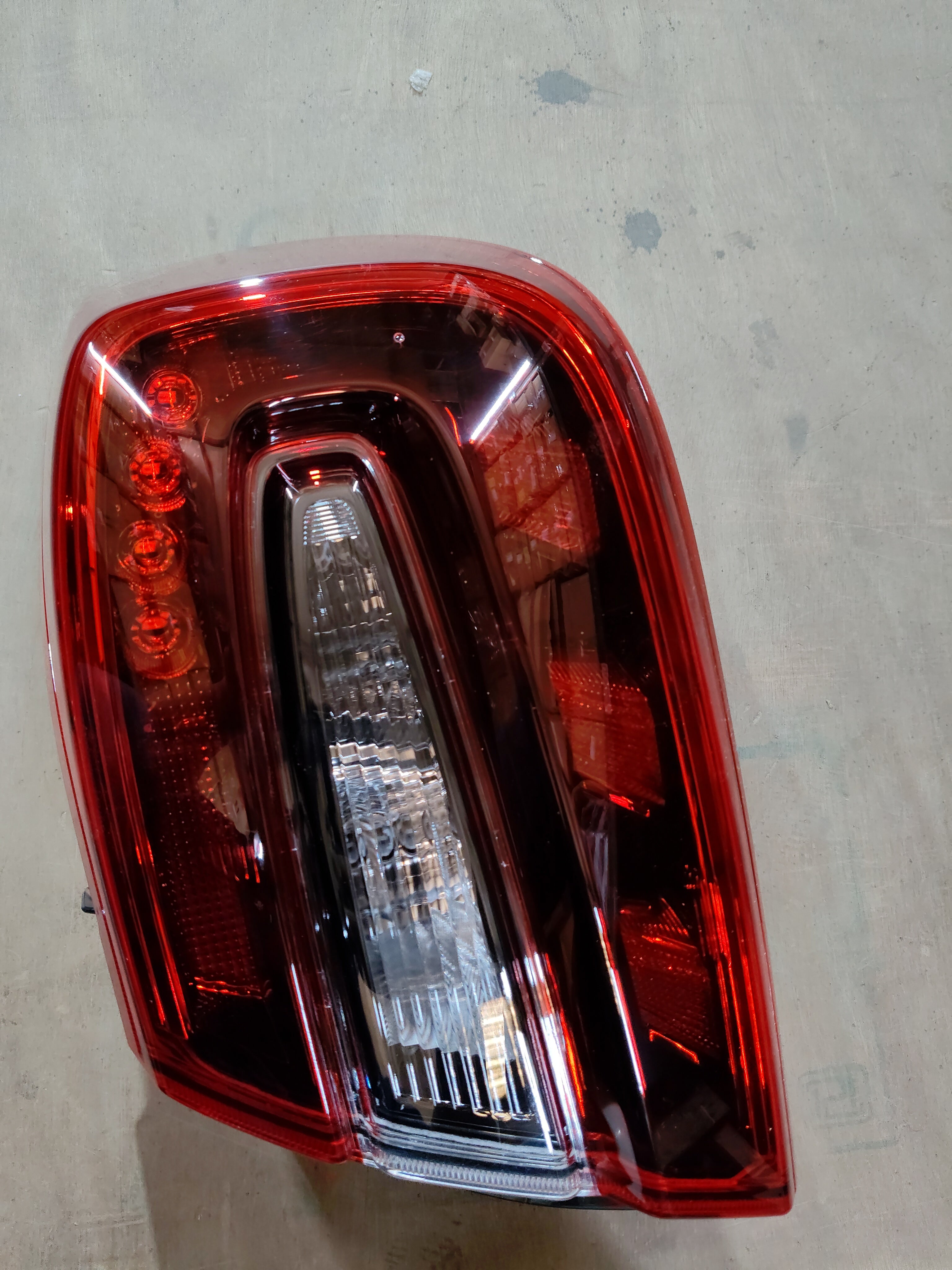 Maruti Suzuki lamp unit RR combination RH 35650M55T12, automotive headlamp component, mounted on vehicle.