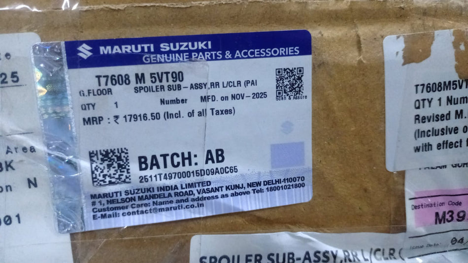 Maruti Suzuki rear left spoiler sub-assembly in clear paint for Invicto T7608M5VT90 model, showing the painted vehicle part.