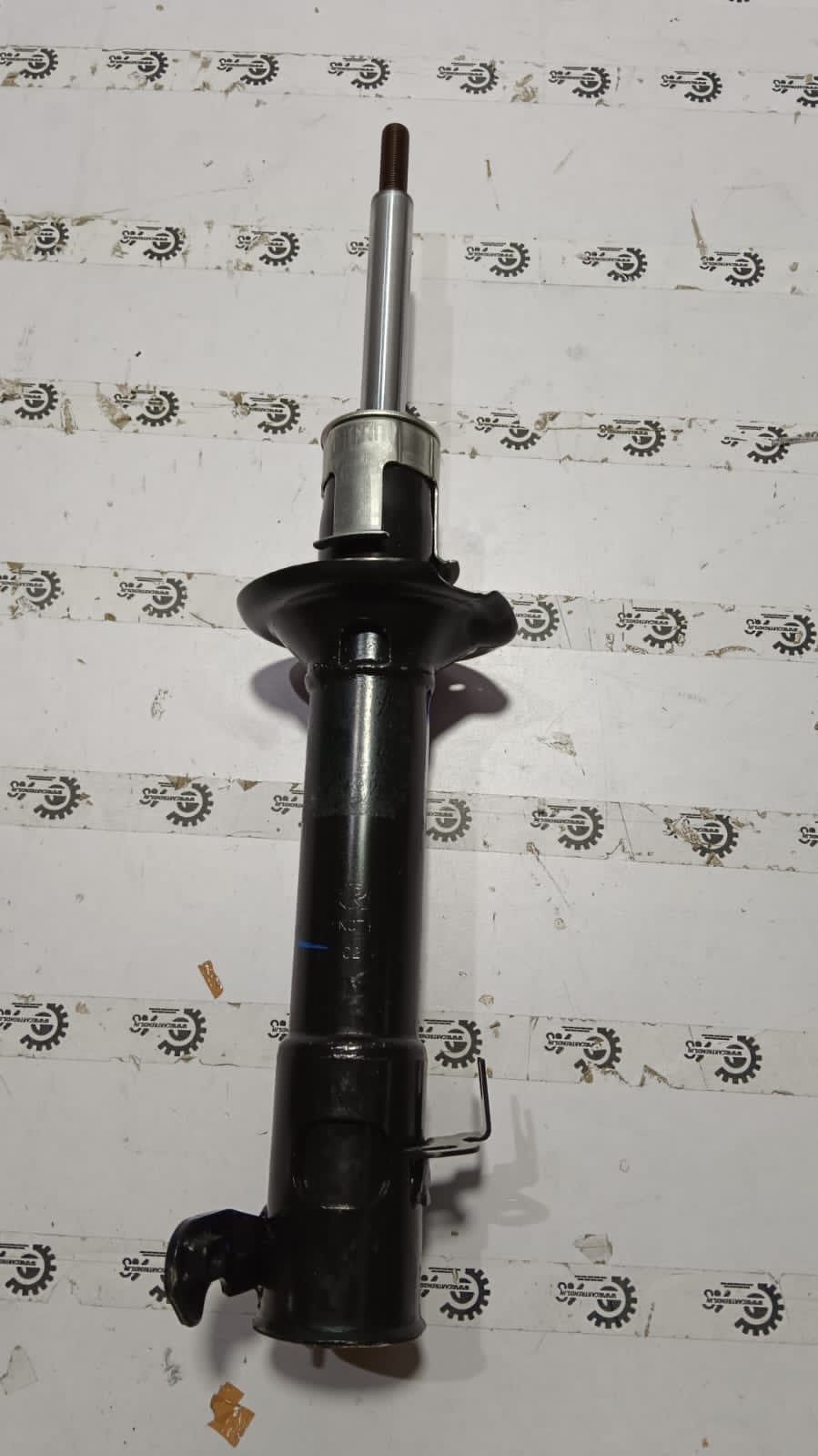 Maruti Suzuki Wagon R front left shock absorber assembly with part number 41602M69R00, shown in close-up.