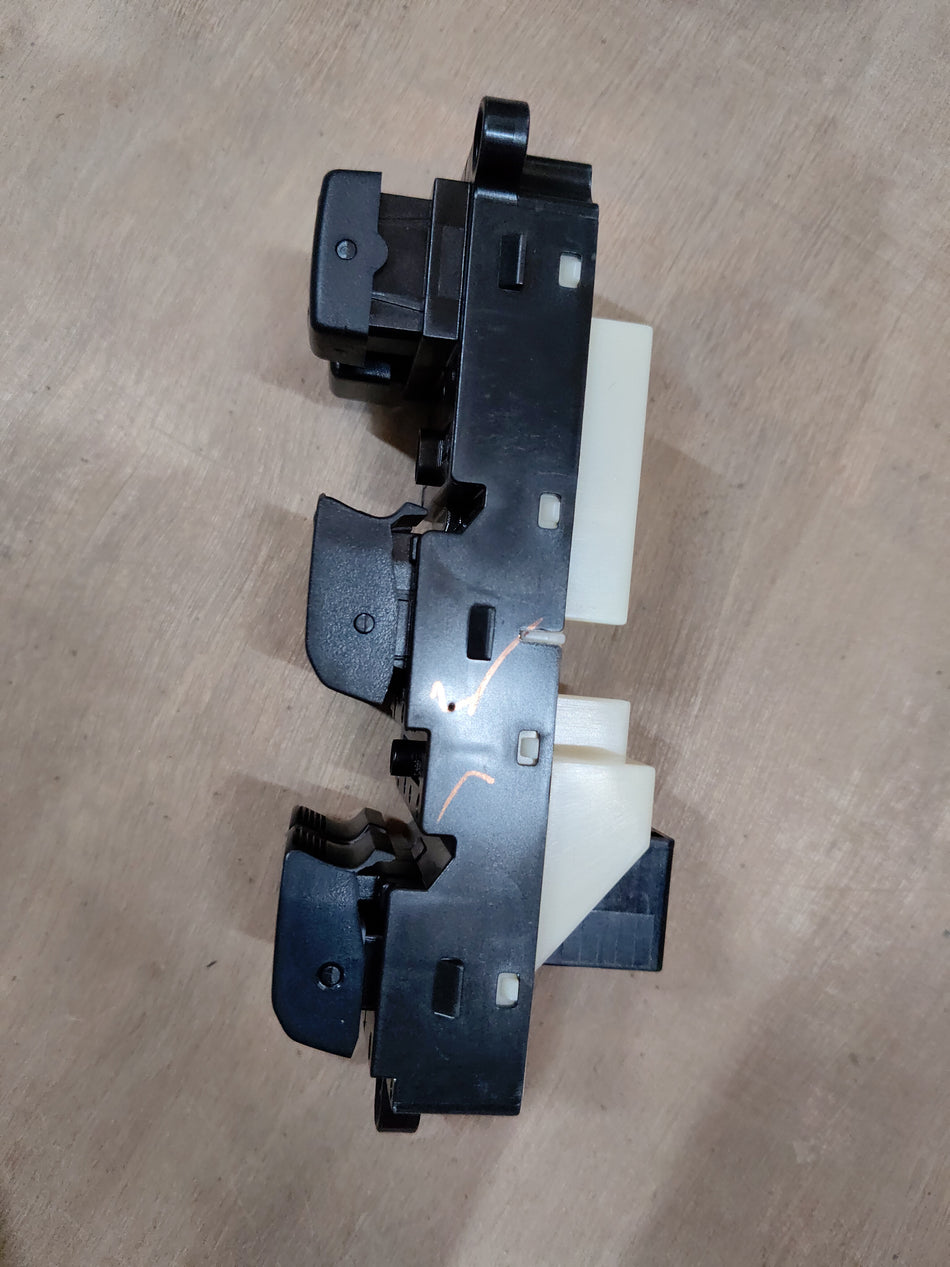 Maruti Suzuki power window switch assembly 37990M56R31, close-up of the black switch with wiring for vehicle window control.