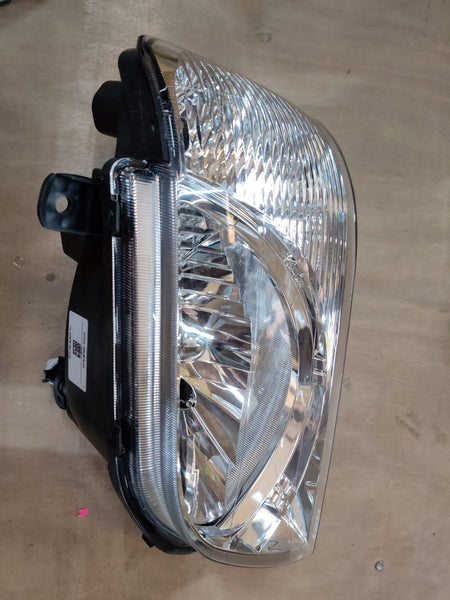 Maruti Suzuki unit headlamp LH 35320M78L01 showing the automotive headlight with clear lens and mounting brackets
