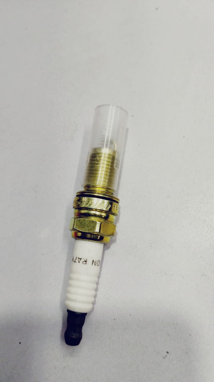 NGK Spark Plug Alto showing the metal and ceramic components of the NGK spark plug for automotive use.