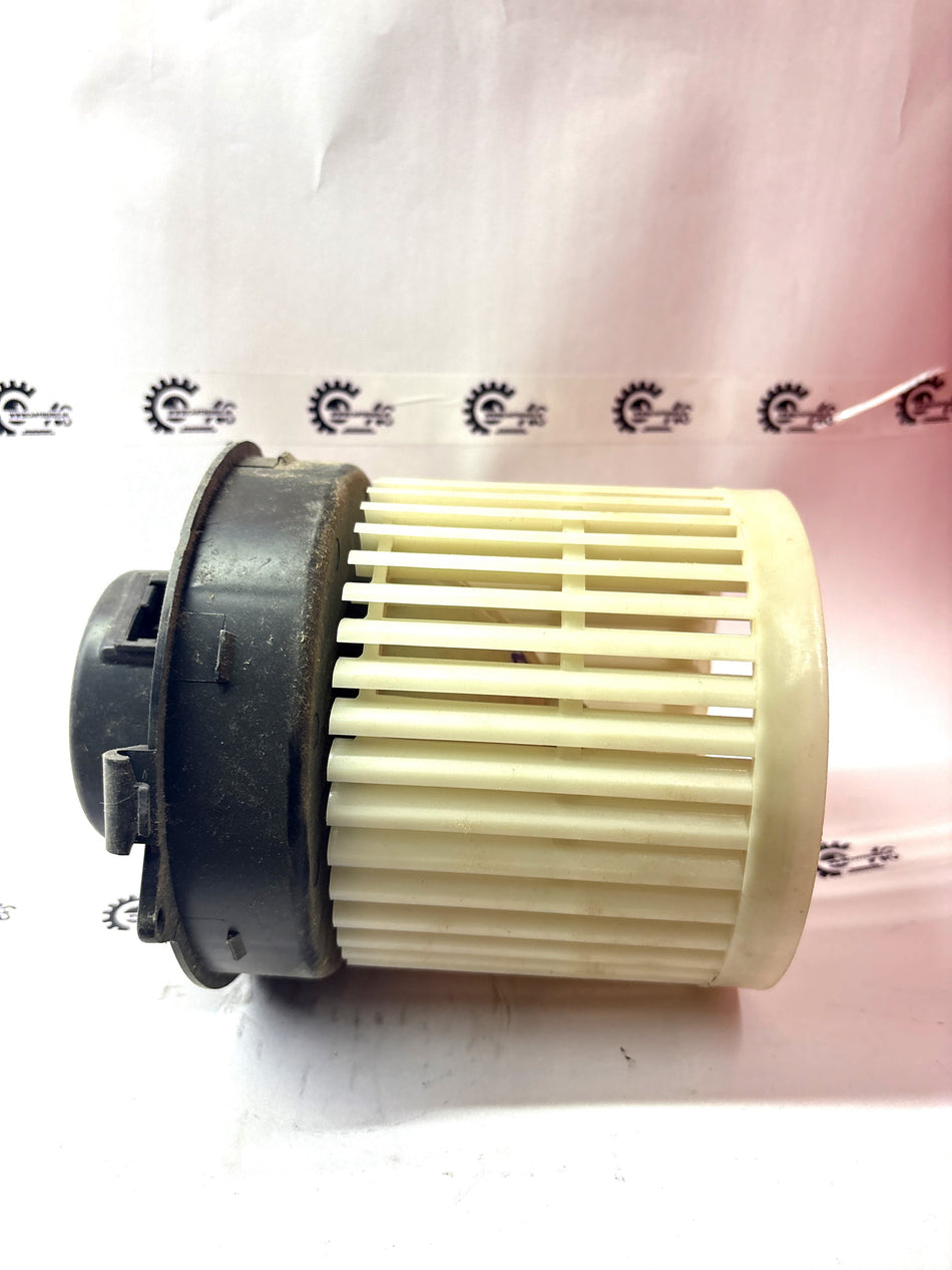 Front Nissan blower assembly, model #272201HH0E, showing the motor and fan components for vehicle heating and cooling system.