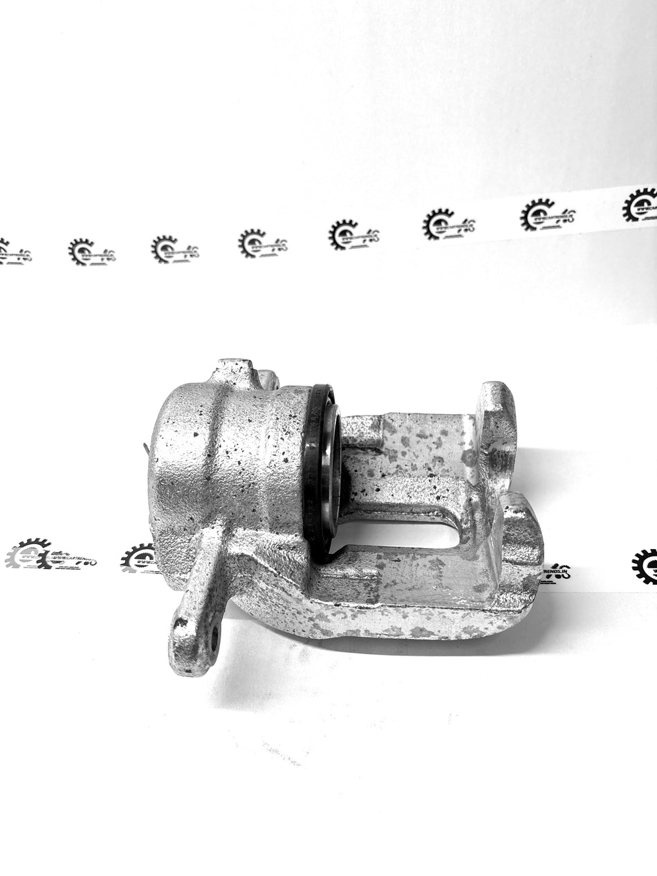 Nissan Micra caliper assembly part #410011HA0B, automotive brake component with metal caliper and hydraulic pistons.