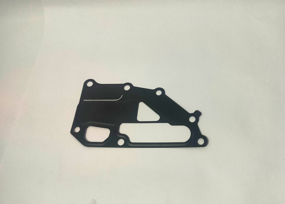 Nissan water outlet gasket part #11062ED000, close-up view showing rubber sealing surface for engine cooling system.