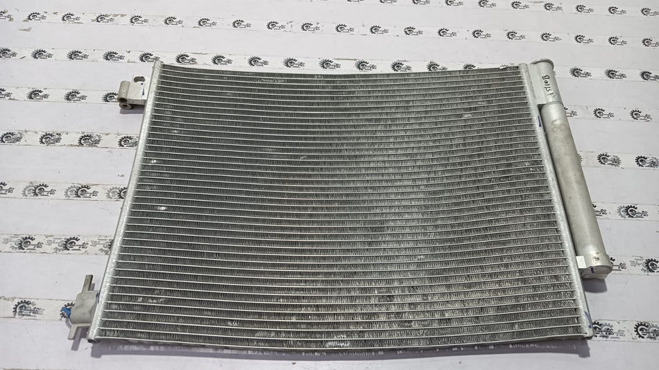 Nissan condenser for Renault Duster vehicle, part number 921006936R, showing the metal radiator component in a car engine bay.