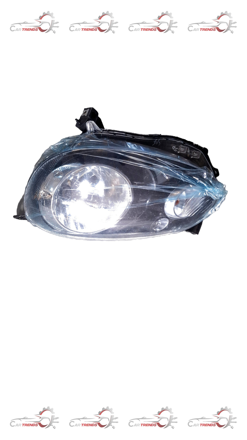 Nissan Micra active left headlight assembly, clear lens showing bulb and housing for vehicle illumination.