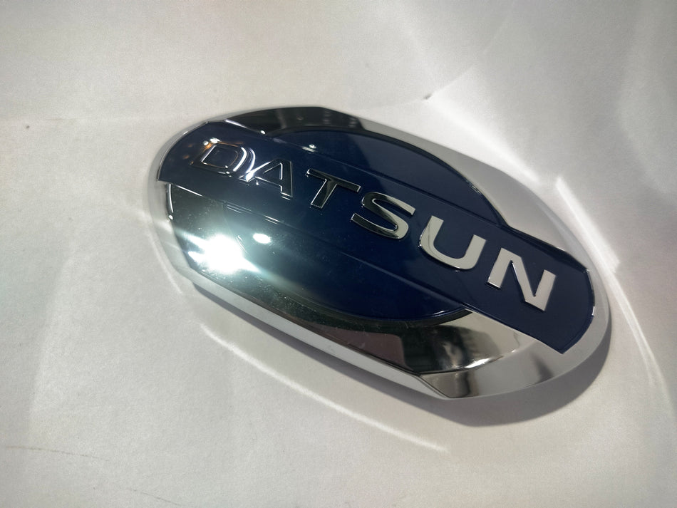 Front view of Nissan Datsun Go emblem, showing the Nissan logo and emblem details on the vehicle's front.