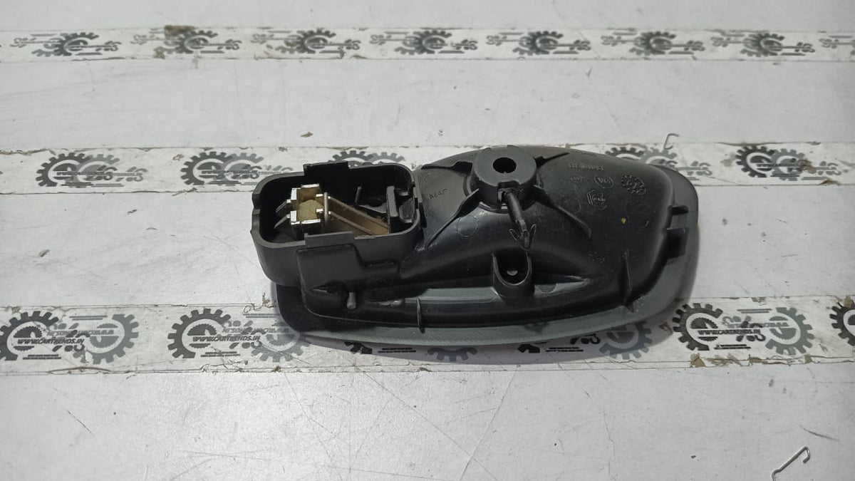 Nissan Fluence right inner door handle in black with silver trim, designed for Nissan vehicle model.