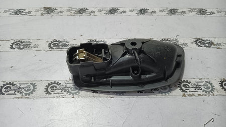 Nissan Fluence right inner door handle in black with silver trim, designed for Nissan vehicle model.