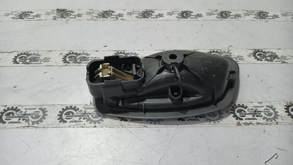 Nissan Fluence right inner door handle in black with silver trim, designed for Nissan vehicle model.