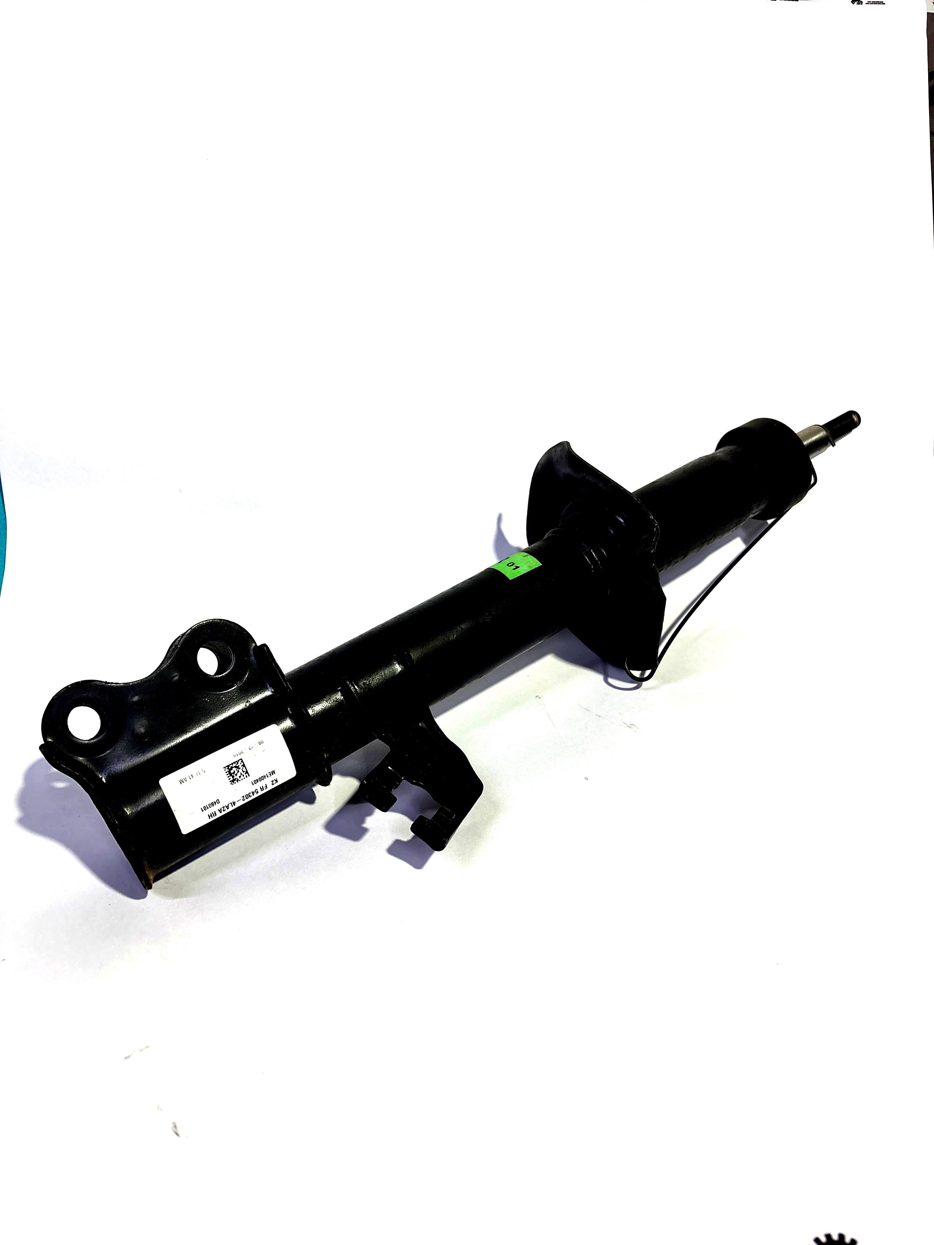 Nissan Datsun Go front right shock absorber, OEM part, showing the metal shock component mounted on the vehicle suspension.