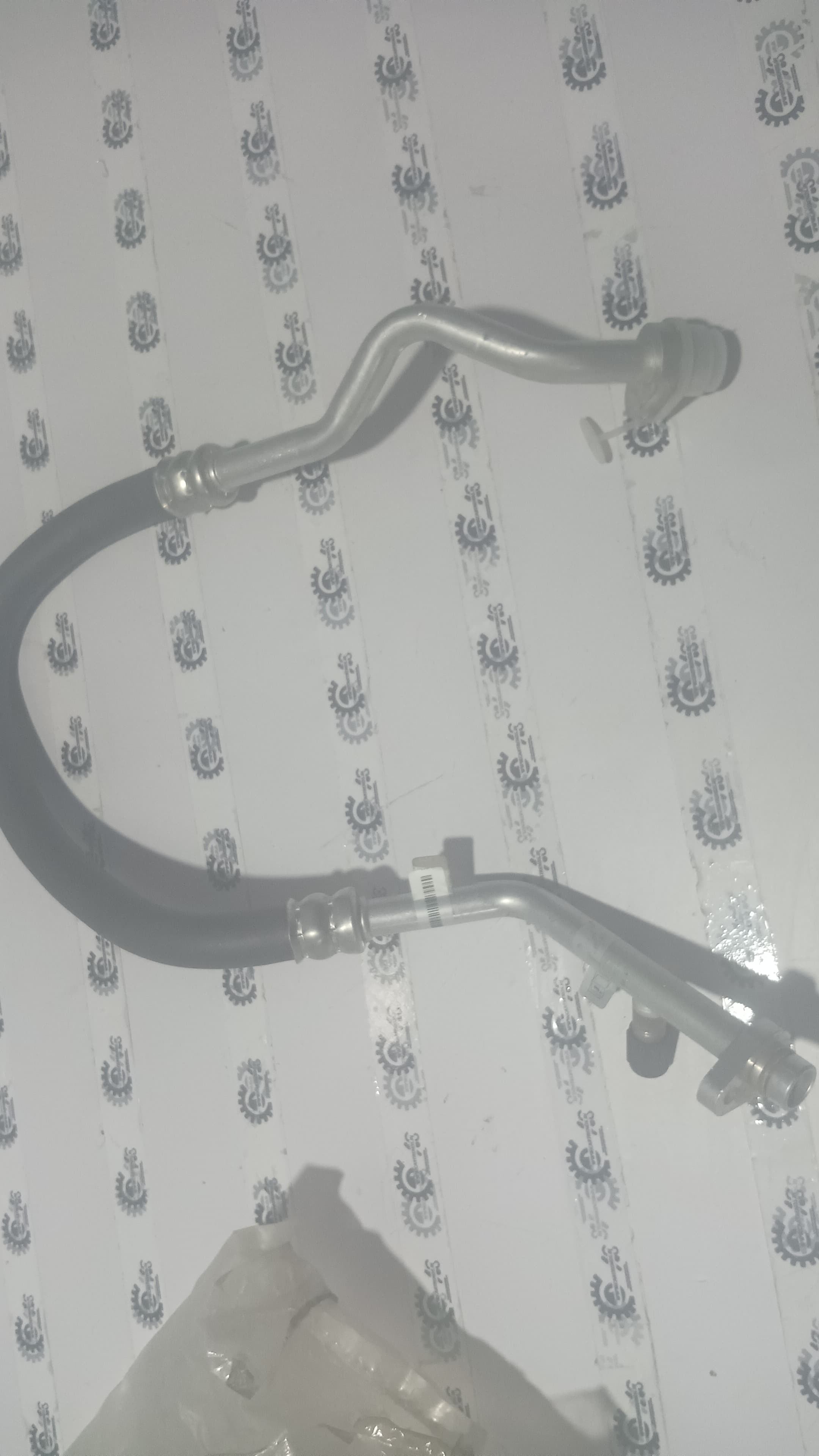Nissan Fluence air conditioning compressor pipe, part #924540019R, showing the metal pipe with connectors for the AC system.