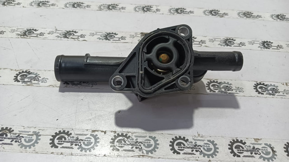 Nissan Kwid thermostat housing part 110600318R, showing the black plastic component with mounting details.