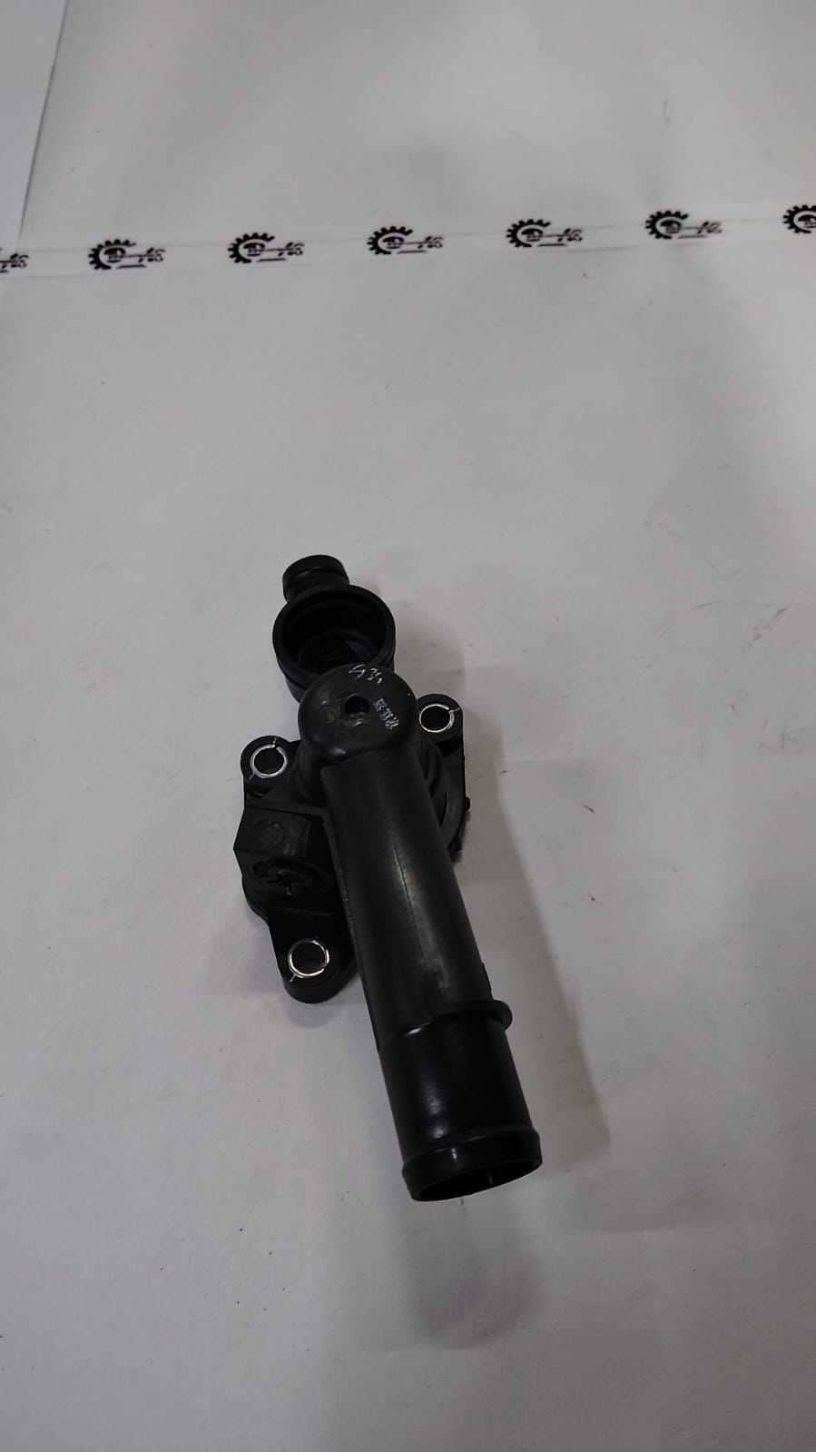Nissan thermostat housing for Kwid model, made of durable material, with mounting points and connection ports visible.