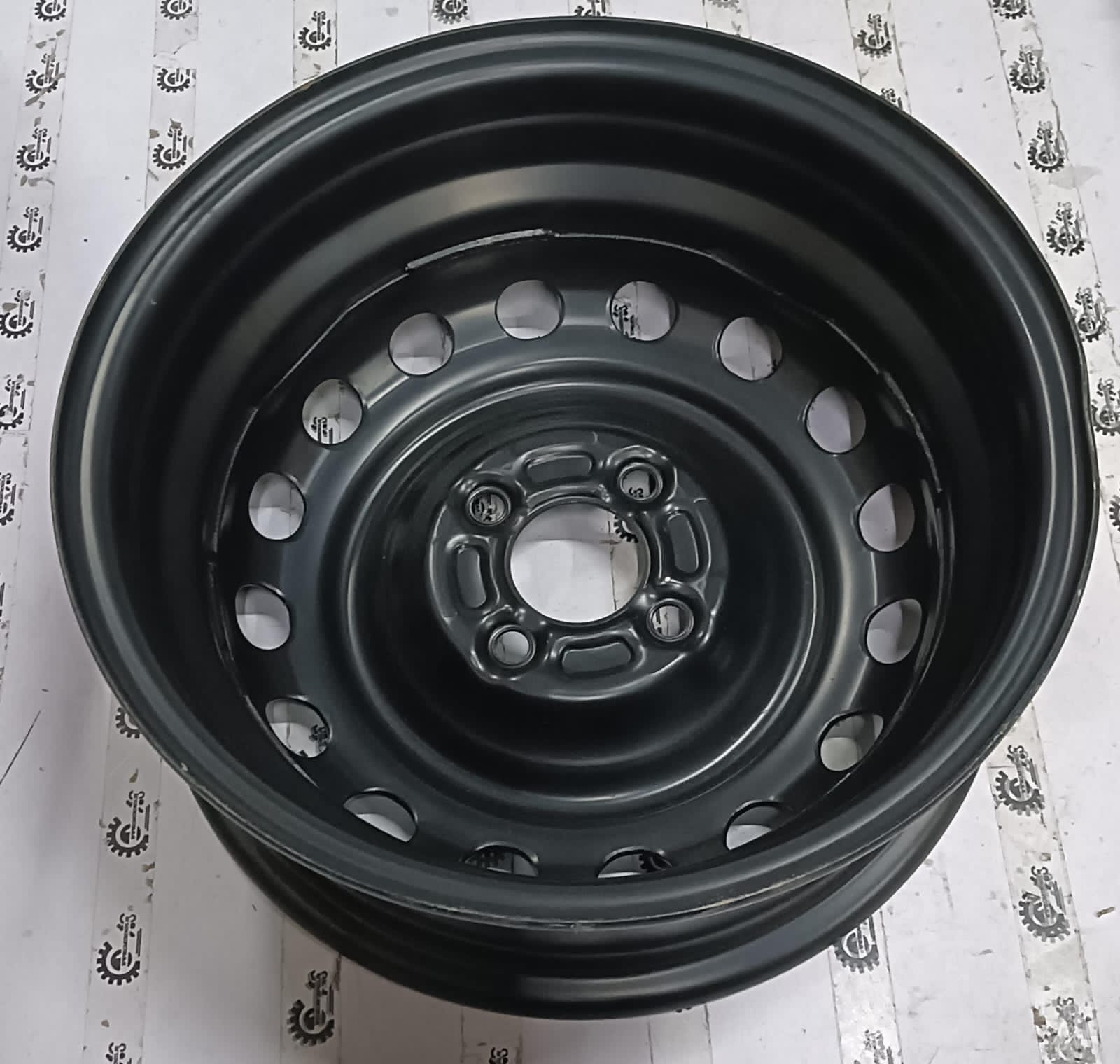 Nissan Pulse wheel rim, black alloy wheel for Nissan vehicle, showing close-up of the rim's design and finish.