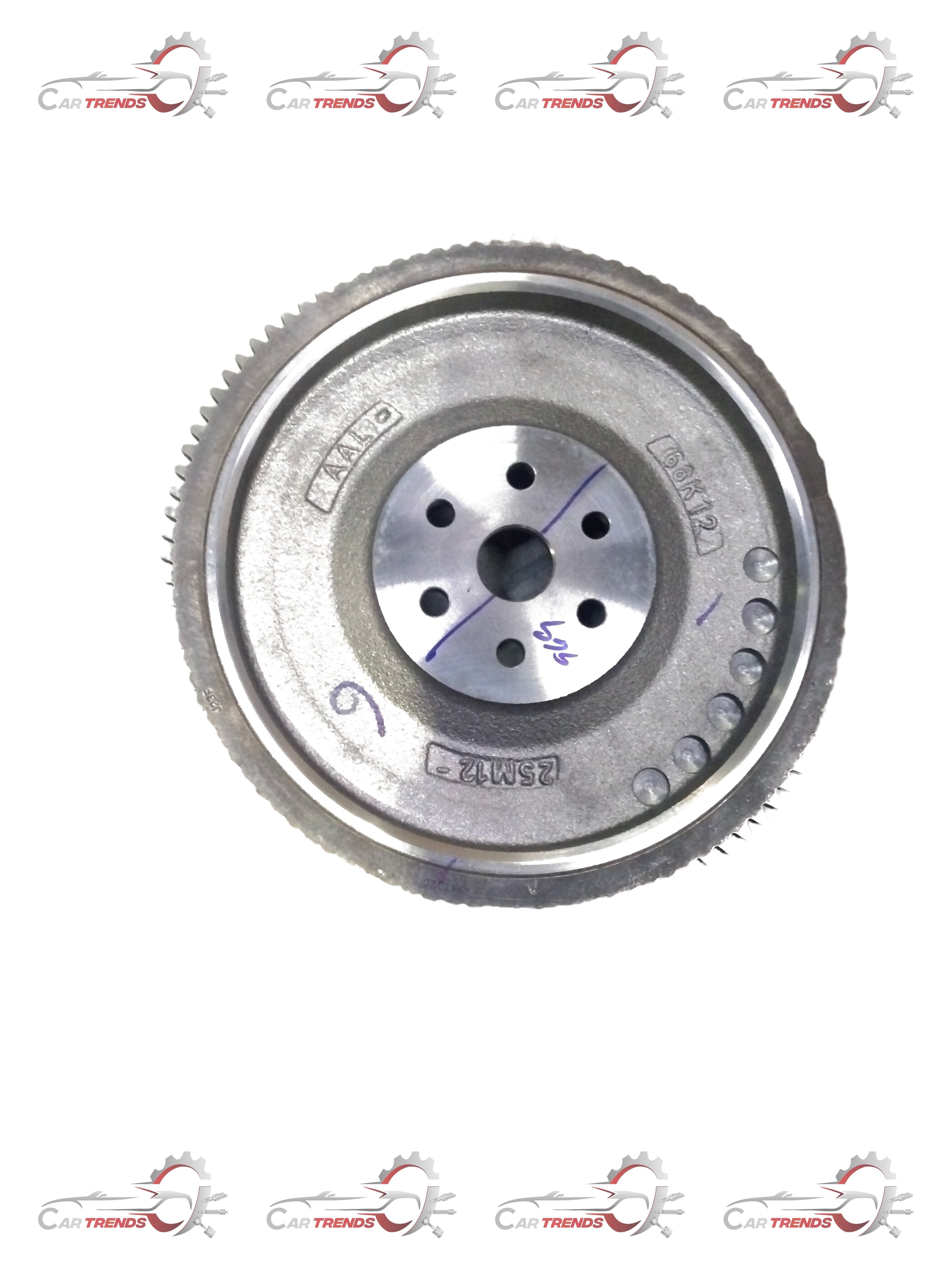 Maruti Suzuki flywheel component labeled FLYWHEEL COMP 12620M68K12, showing a metallic automotive part with detailed surface features.