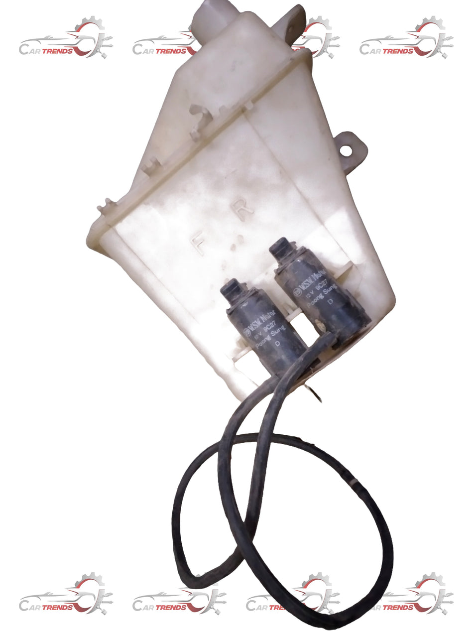 Chevrolet Aveo CarTrends wiper bottle spare part with label and cap, close-up view of the automotive fluid container.