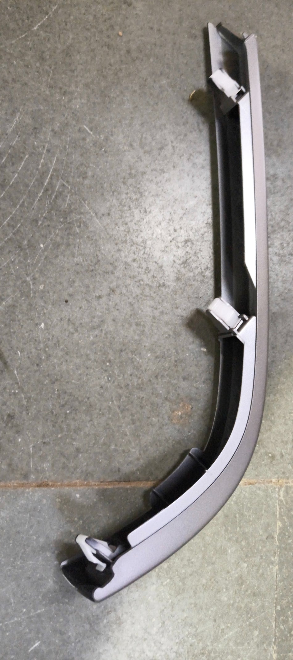 Honda GARN ASSY.AS LWR 77260T9AT01ZA rear garnish assembly, showing the detailed plastic and metal components.